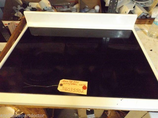 FRIGIDAIRE STOVE 316035502 MAIN TOP ASSY. GLASS/STEEL WHITE USED FRIGIDAIRE STOVE 316035502 MAIN TOP ASSY. GLASS/STEEL WHITE USED